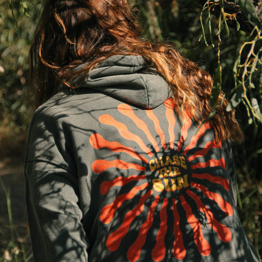 Person wearing a jacket with a red and orange abstract design outdoors