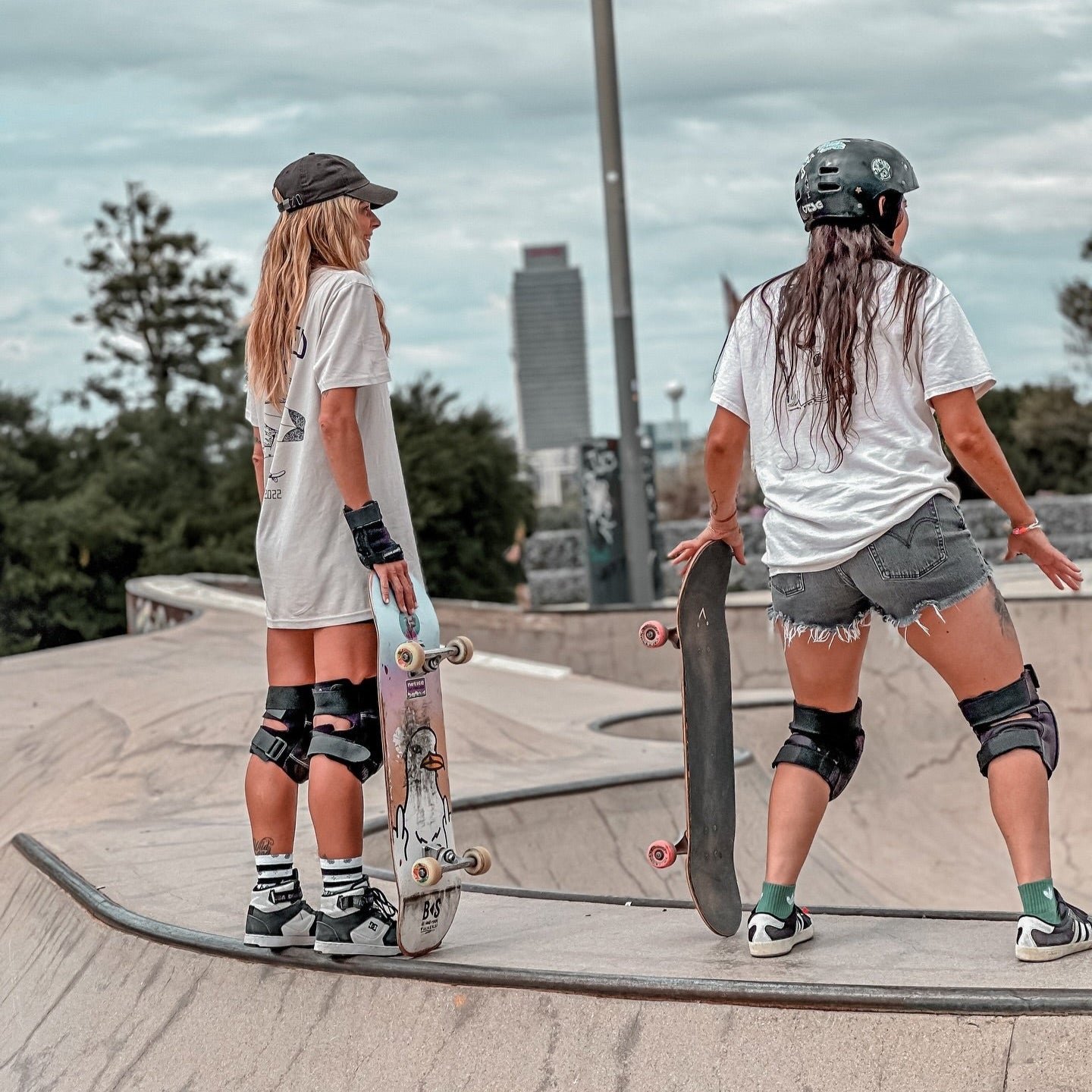 girls skating in barcelona wearing stoked guy original bone t shirt