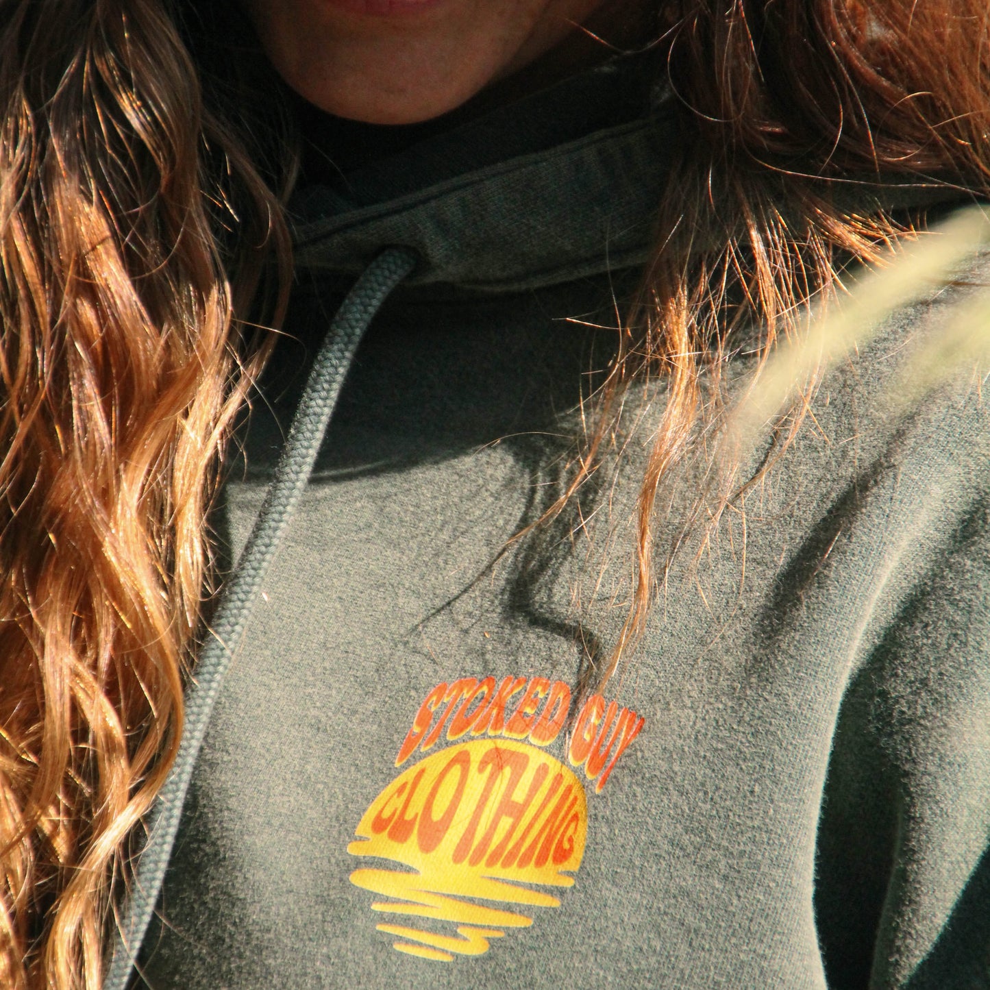 Person wearing a hoodie with 'Spaced Out Clothing' logo