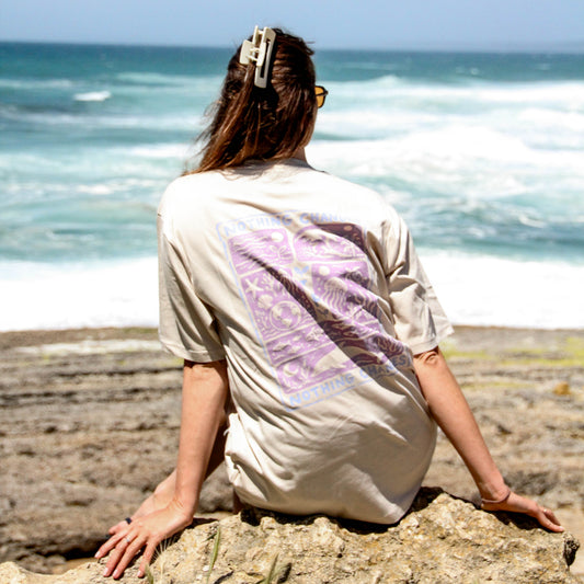 Person sitting on a rock by the ocean