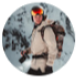 Person wearing a winter coat and helmet with a snowy landscape in the background