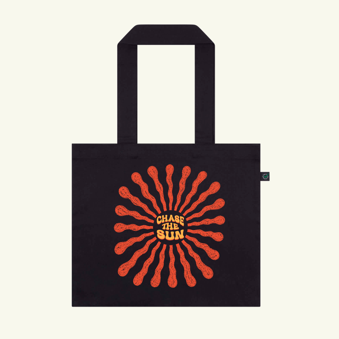 Black tote bag with red and yellow design and text 'Chase the Sun' on a white background