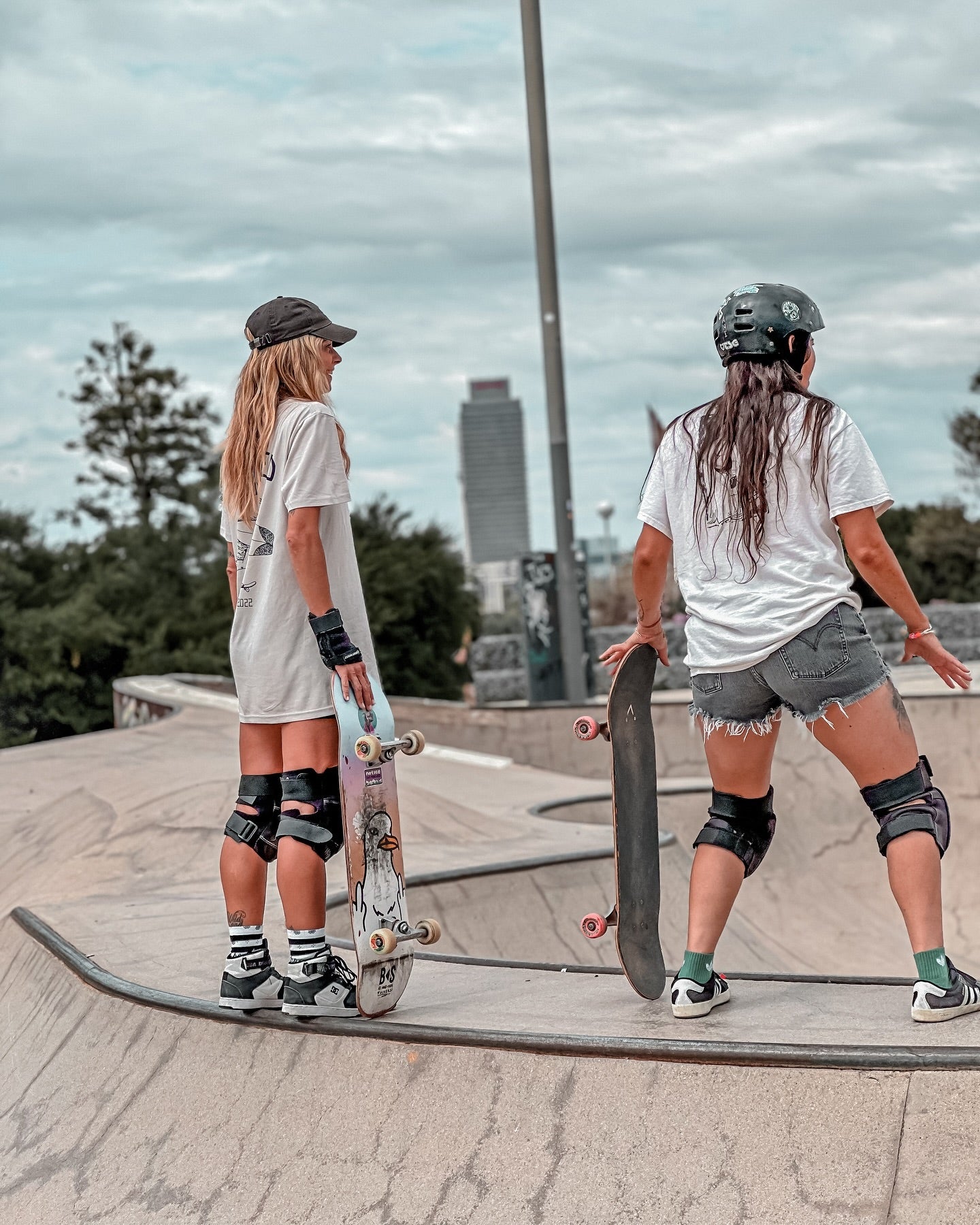 girls skating in barcelona wearing stoked guy original bone t shirt